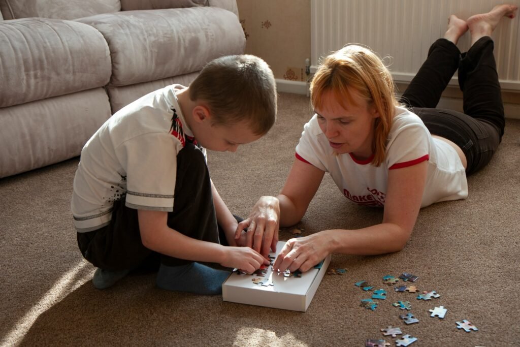 A boy and his mother work together on a jigsaw puzzle.
best teacher training institute Borivali, Mumbai.