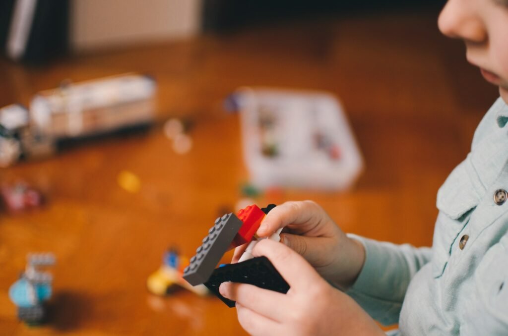 A child is playing with LEGO bricks.
best teacher training institute Borivali, Mumbai.