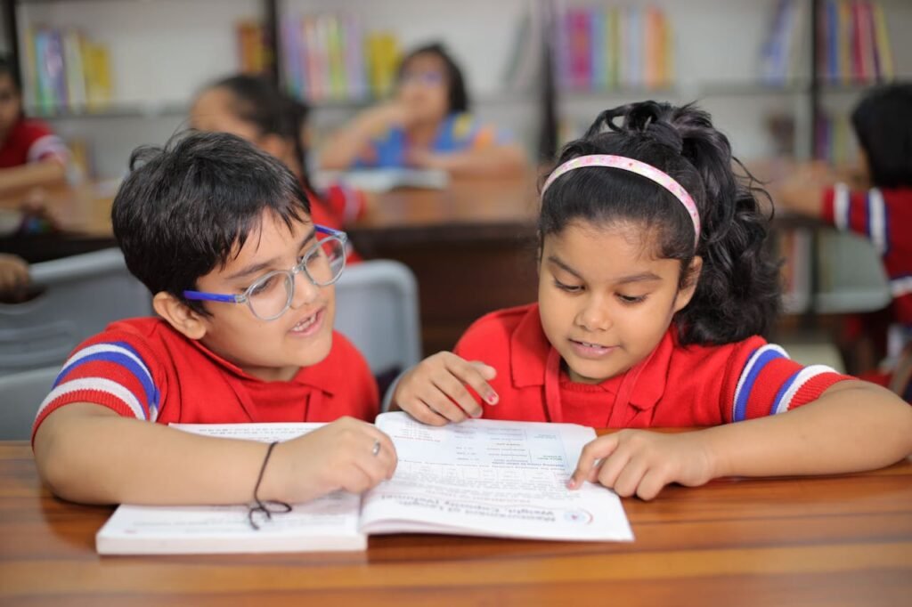 Two children reading together in class.