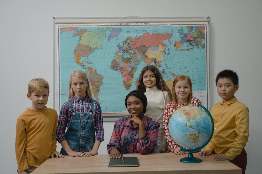 A diverse group of children joyfully standing together in front of a large globe, exploring the world around them.
Best Jolly Grammar Teacher Training Institute in Mumbai Borivali