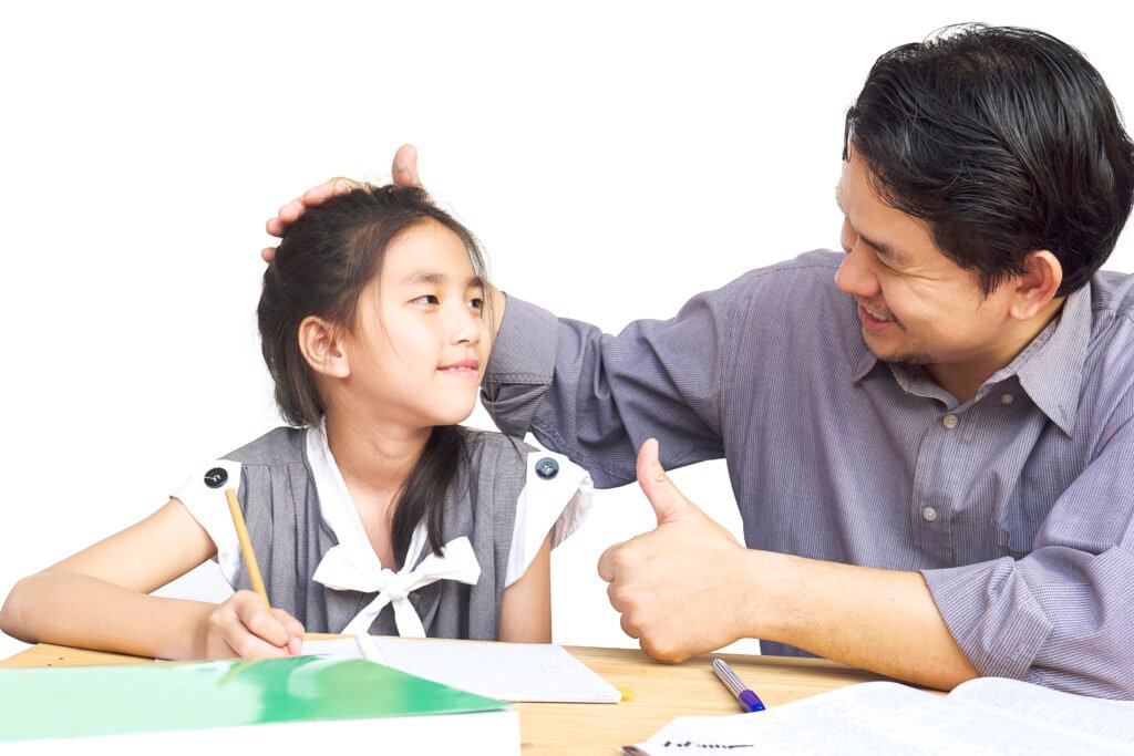 A father encouraging his daughter and helping her with her studies.